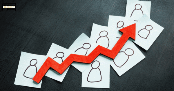 Red arrow pointing upward over hand-drawn people icons on sticky notes, symbolizing growth or increase in numbers.